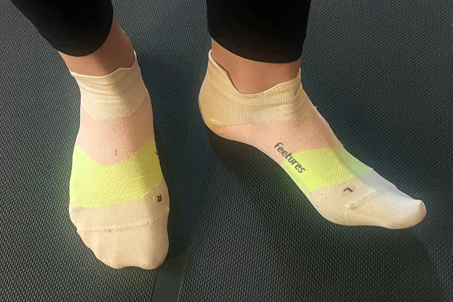 A person wears the Feetures Elite Ultra Light Tab Socks