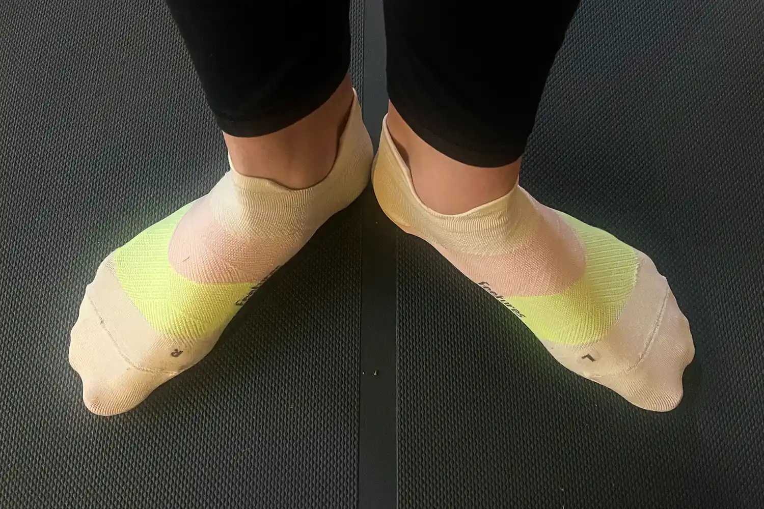 A person wears the Feetures Elite Ultra Light Tab Socks