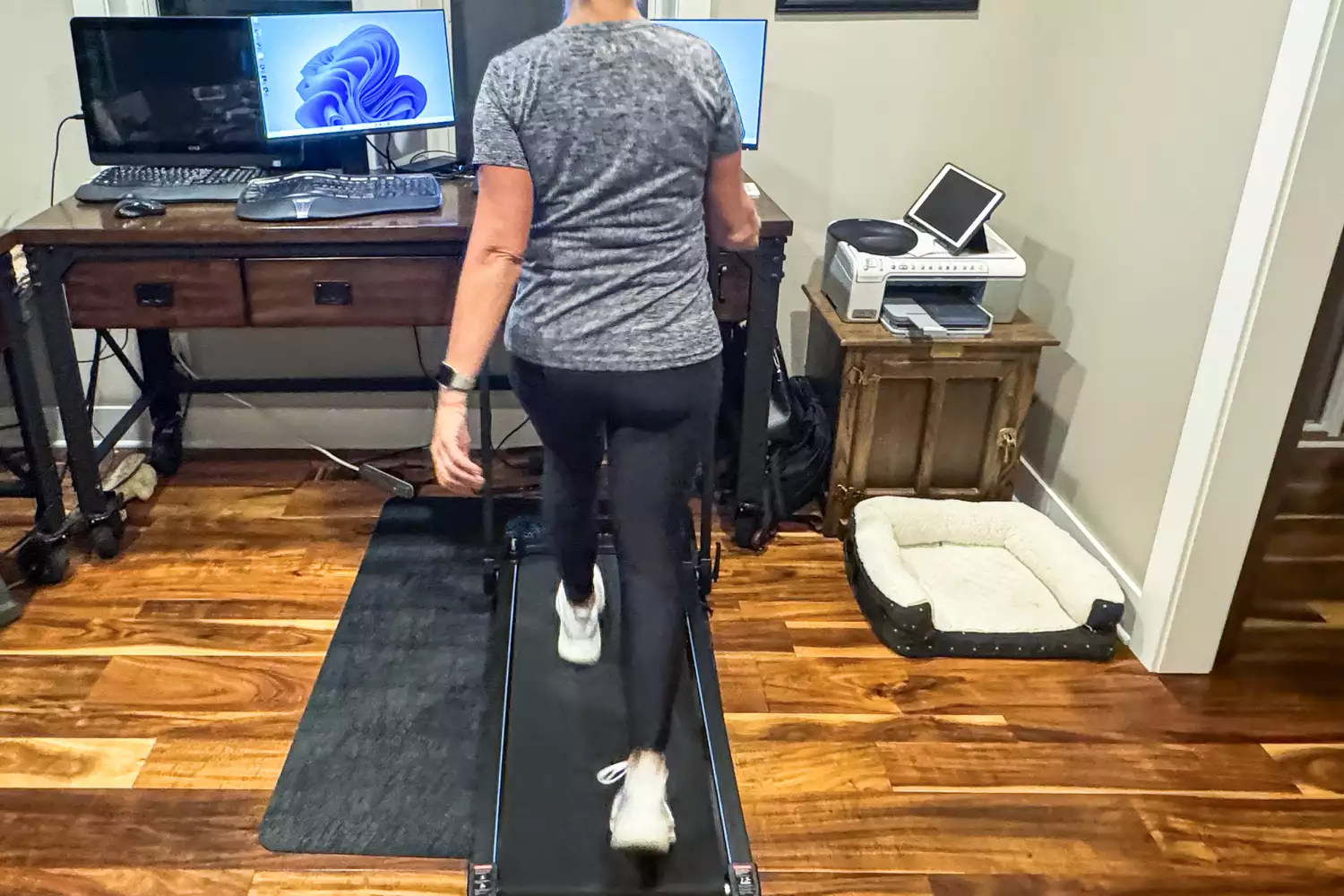 A person walks on the GoPlus folding treadmill 