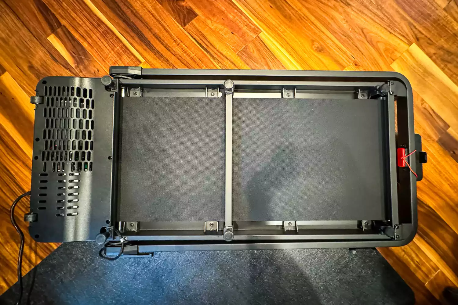 The GoPlus 2 in 1 Folding Treadmill folded on a wooden floor