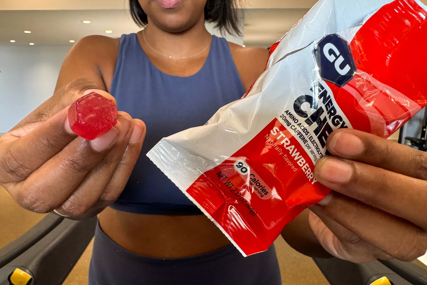 A person displays one of the GU Energy Chews after removing it from the package
