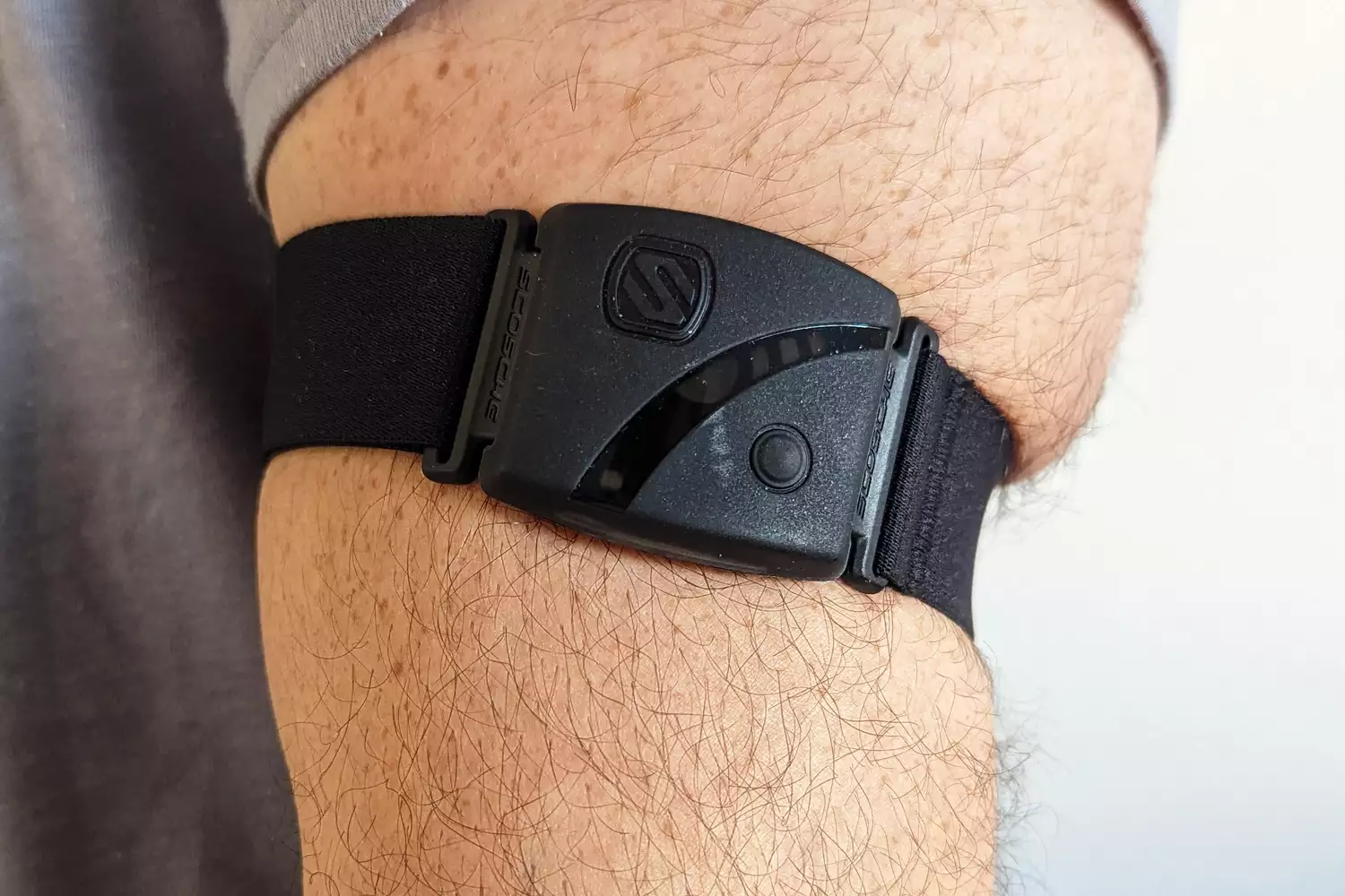 Close up of a Scosche Rhythm24 Waterproof Armband Heart Rate Monitor on someone's arm