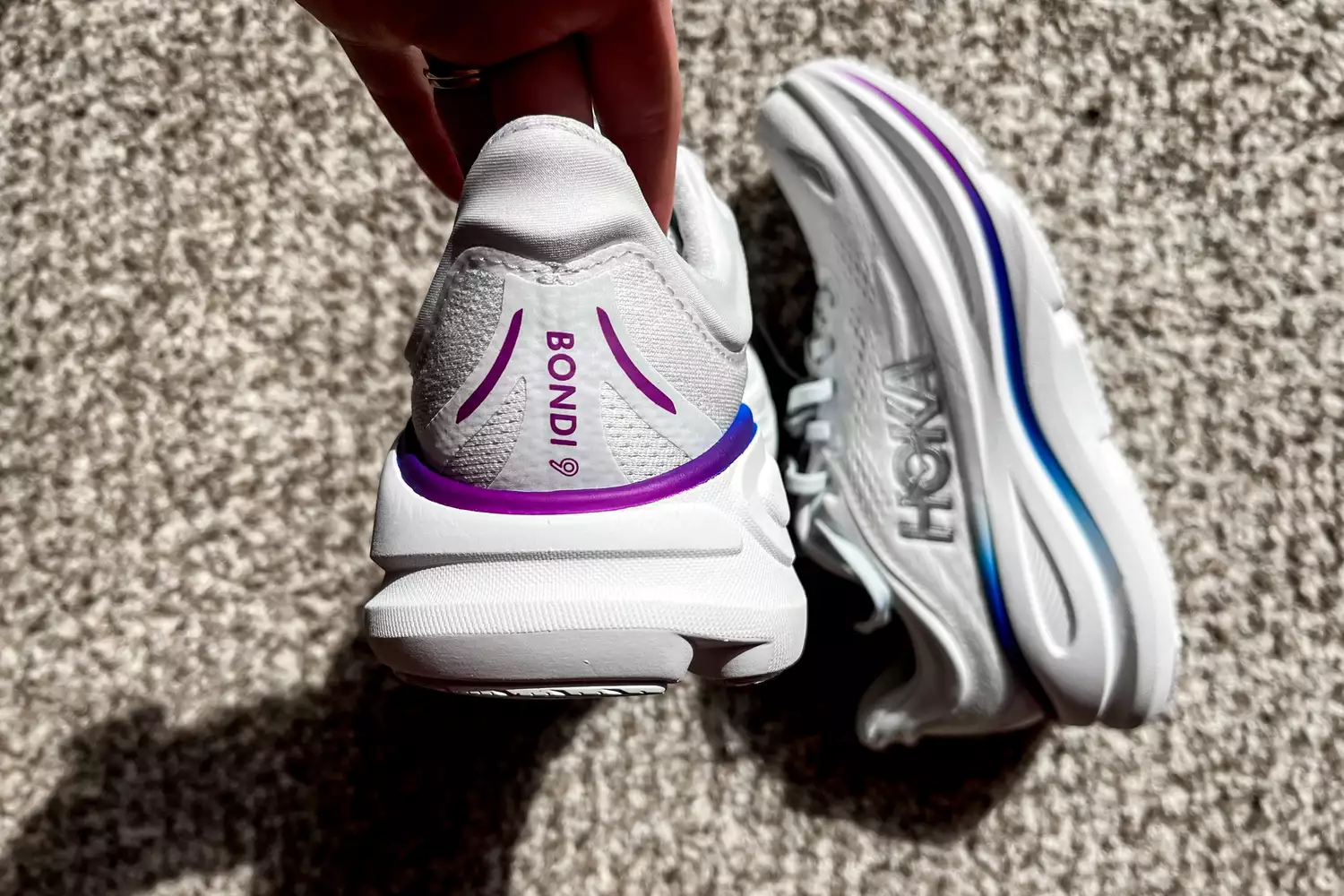 A hand showing the back of a Hoka Women's Bondi 9
