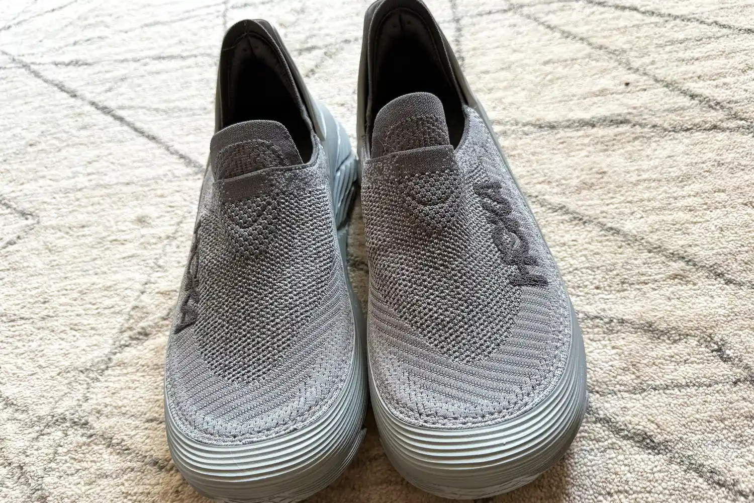 A front view of a pair of Hoka Restore TC Recovery Shoes