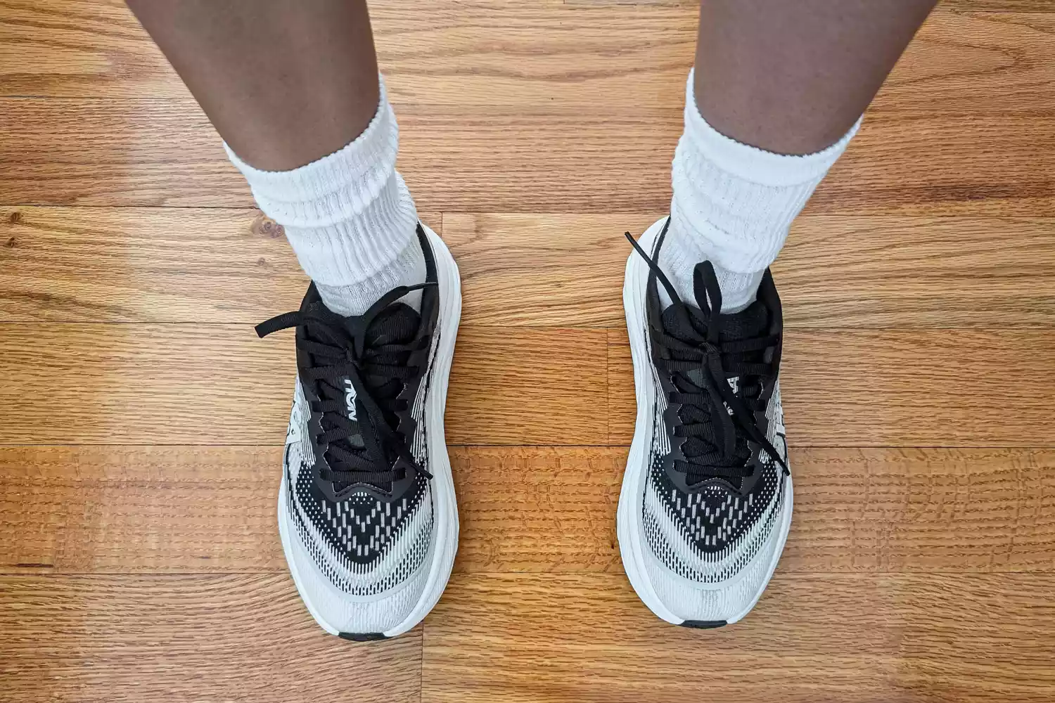An overhead view of the Hoka Women's Skyflow worn on a wooden floor