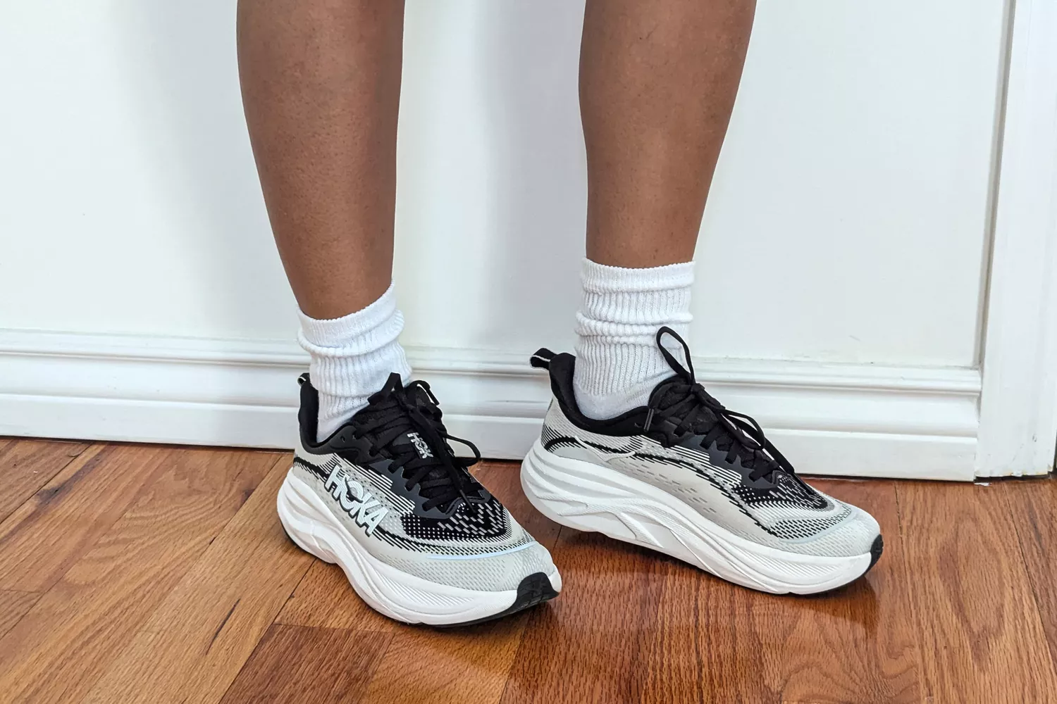 A close-up of two feet in the Hoka Women's Skyflow