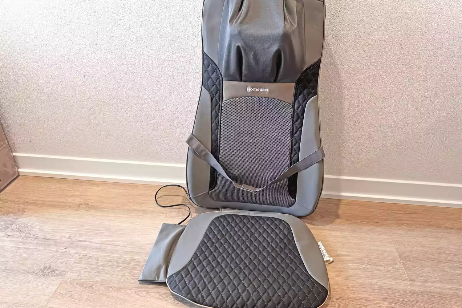 TheHomedics Shiatsu Elite II Massage Cushion with Soothing Heat sitting upright on a wooden floor