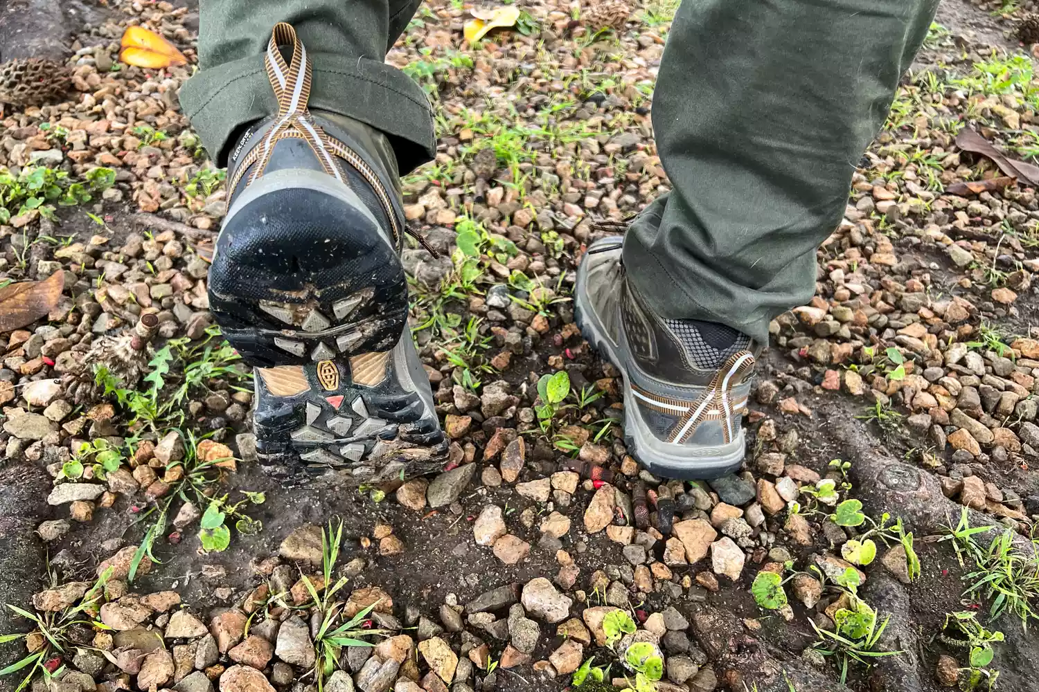 Person hiking on a rocky trail wearing KEEN Targhee III Mid Waterproof Hiking Boots