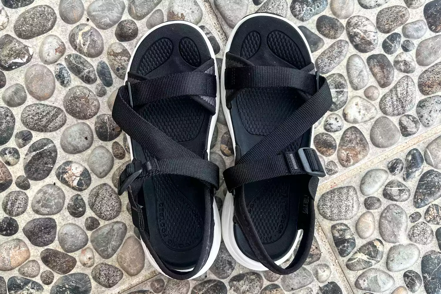 An overhead view of the Keen Women's Leiki Open-Toe Sandal on stones