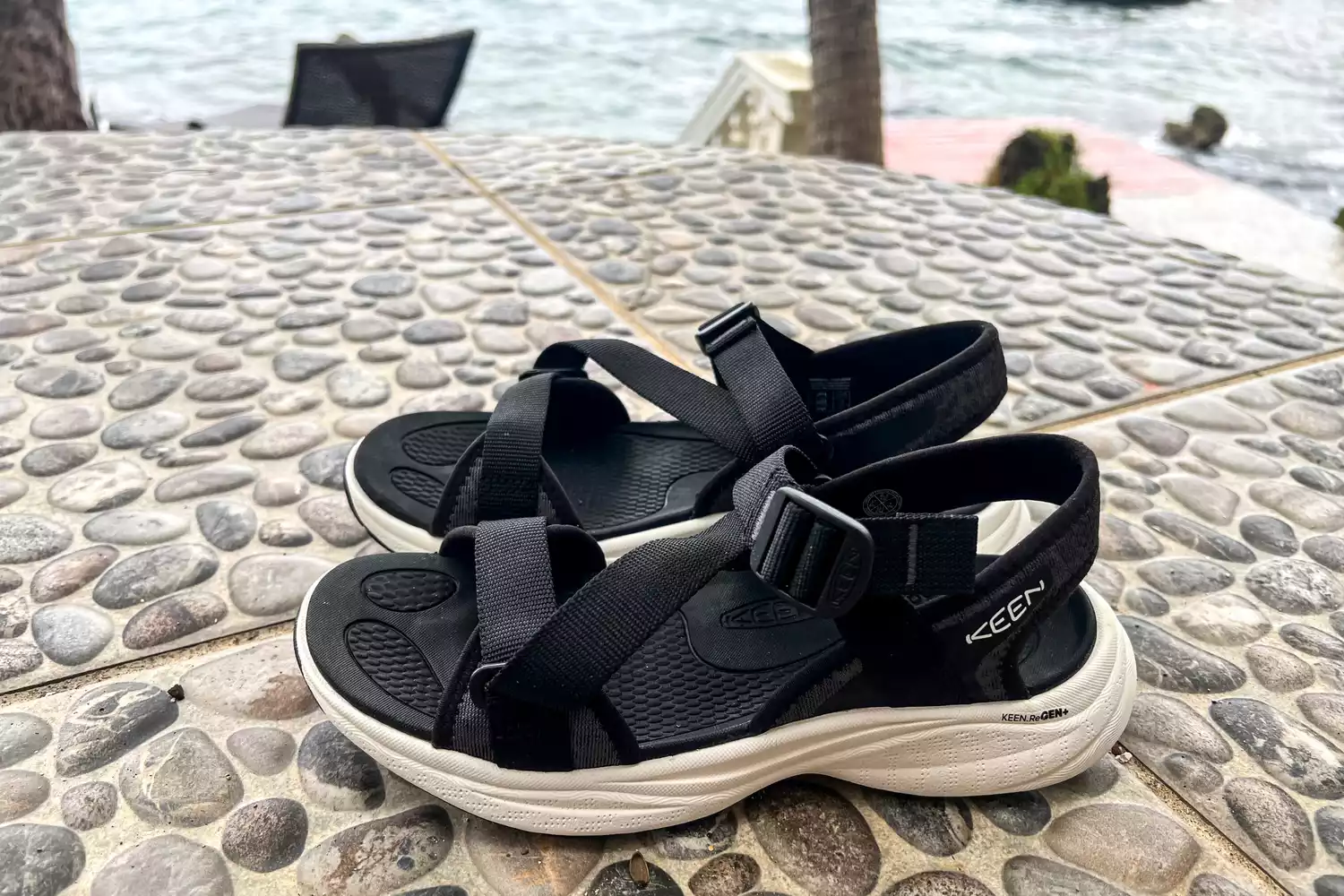 The Keen Women's Leiki Open-Toe Sandal from the side angle on stones