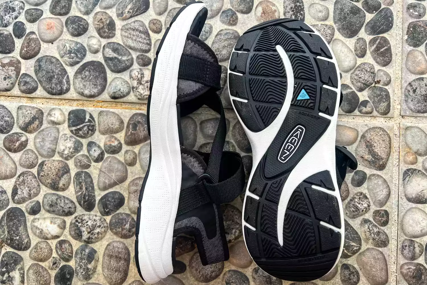 The Keen Women's Leiki Open-Toe Sandal posed on stones