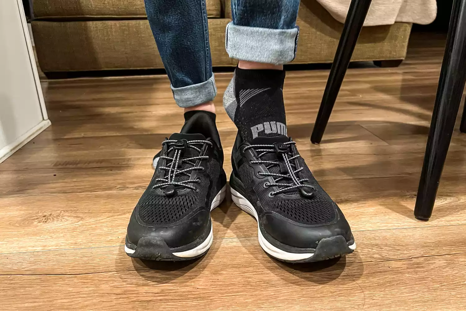 A person sliding a foot into the Kizik Men's London