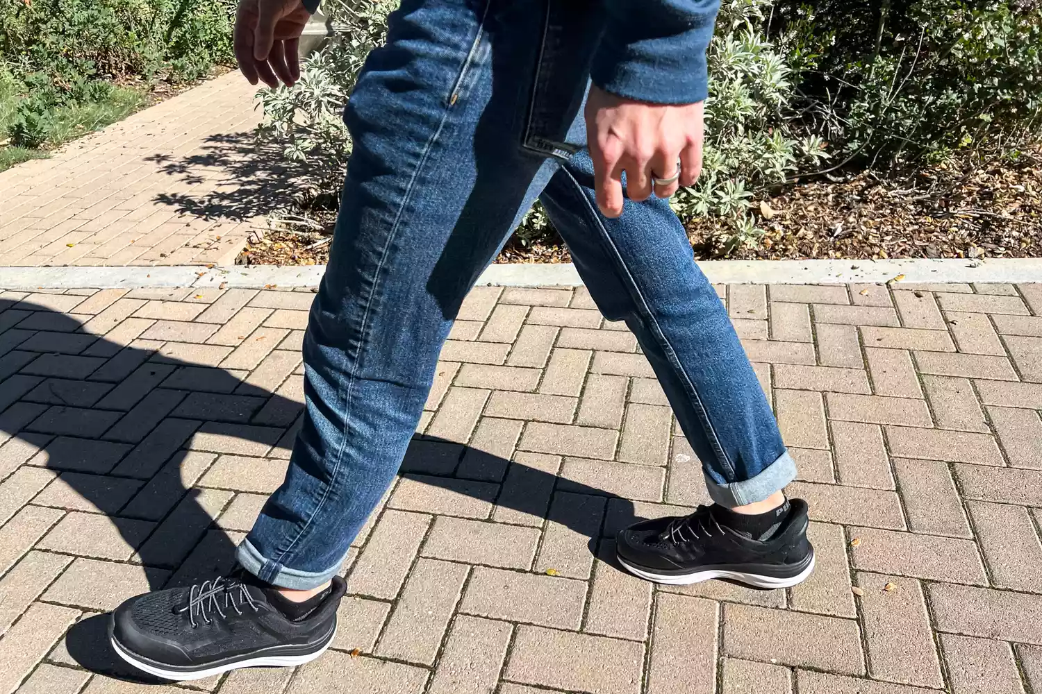 A person's legs walking on tiles while wearing the Kizik Men's London