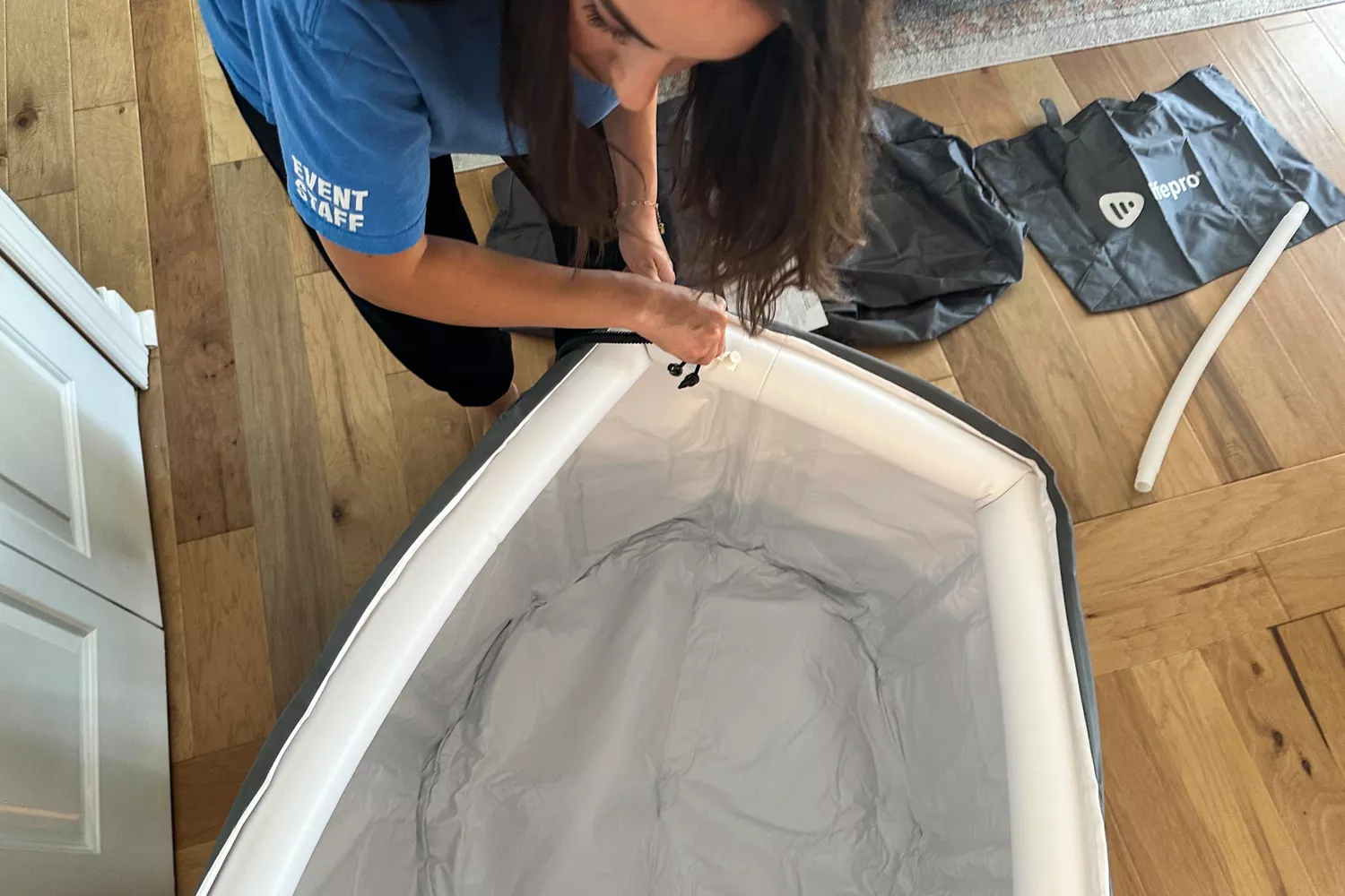 A person setting up the Lifepro Allevachill Recovery Ice Tub