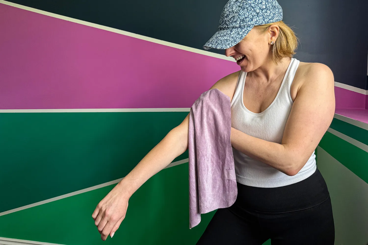 A person dries off after exercise using the lululemon The (Small) Towel