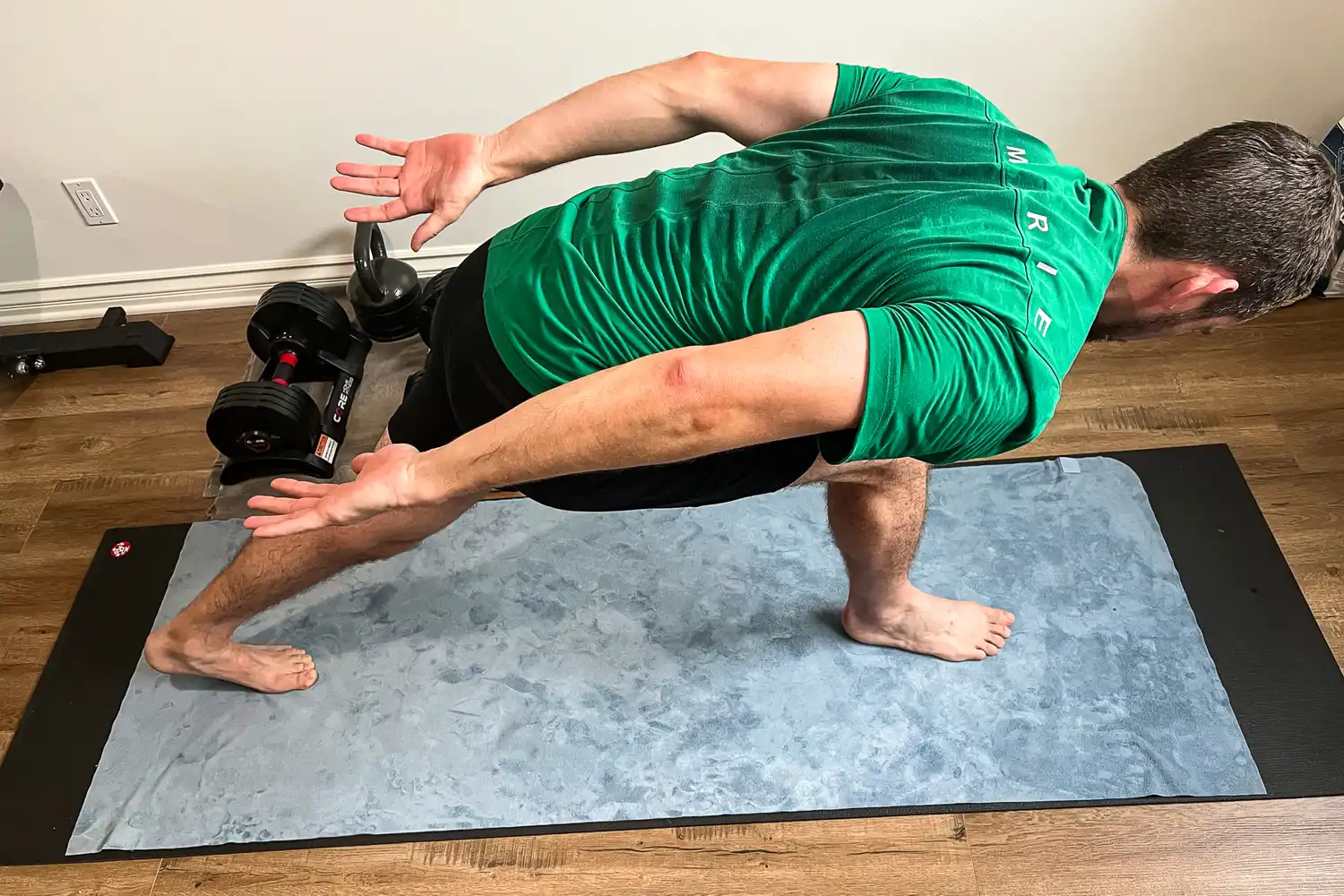 A person does yoga on the lululemon The Towel