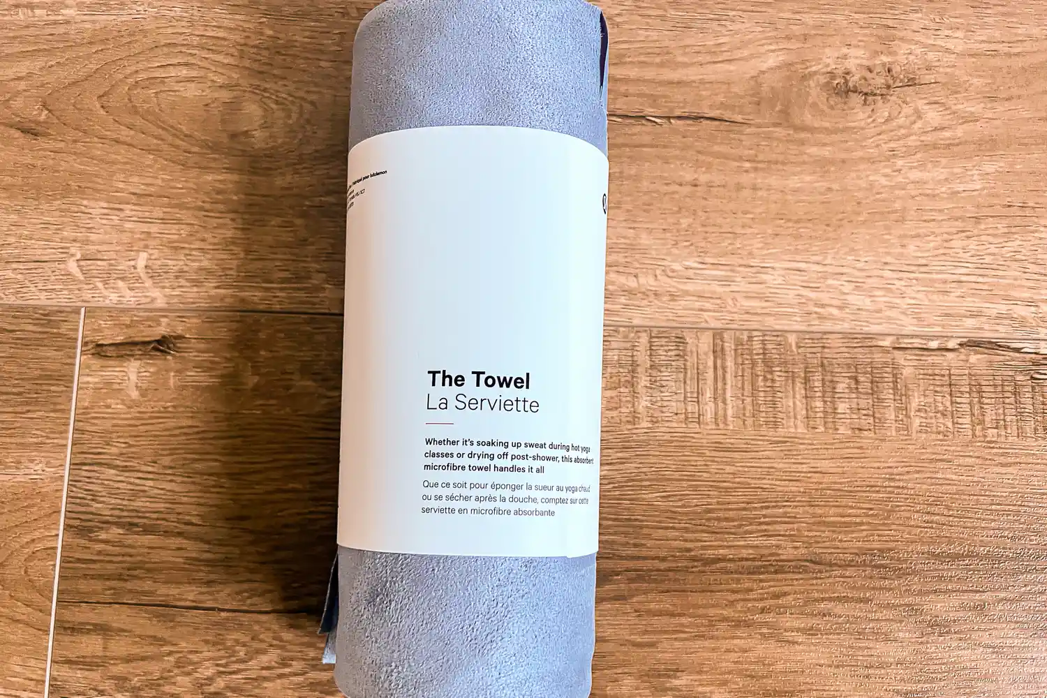 The lululemon The Towel rolled up in paper packaging