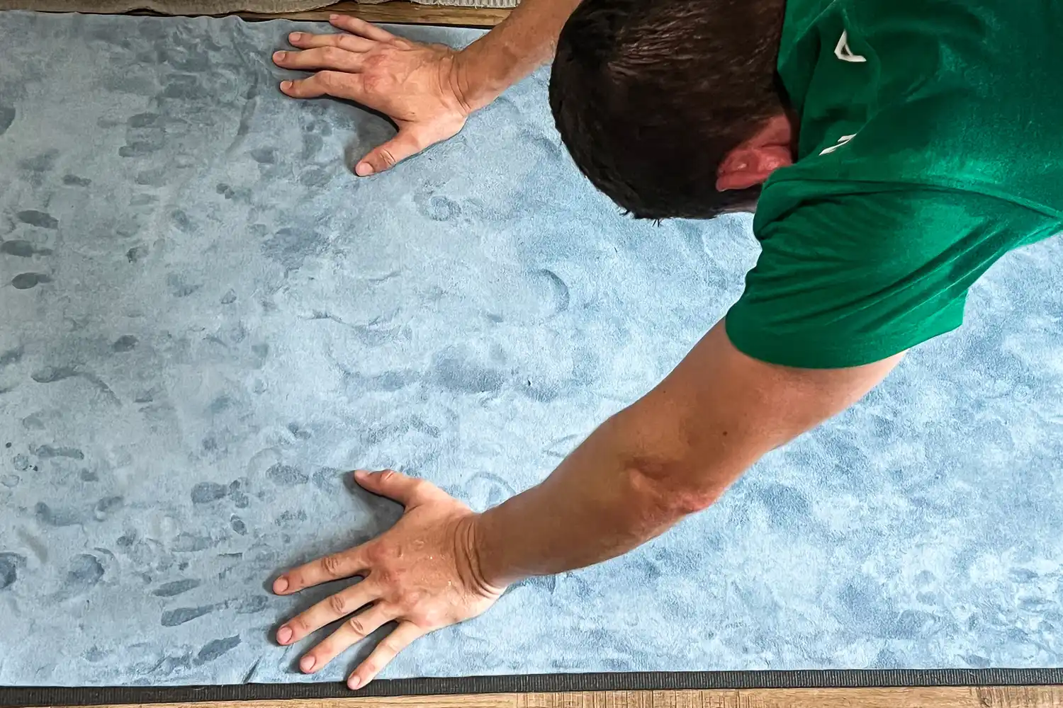 A person does yoga on the lululemon The Towel