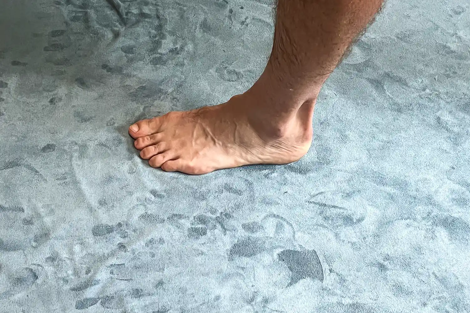 A person stands on the lululemon The Towel