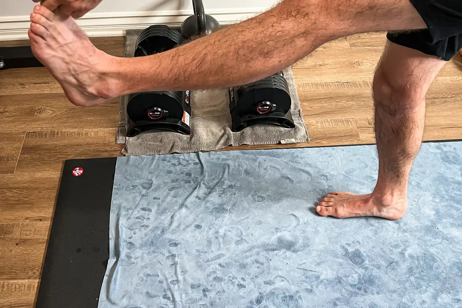 A person does yoga on the lululemon The Towel