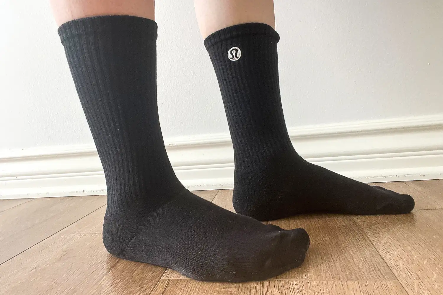 A person wears the lululemon Unisex Daily Essential Crew Socks