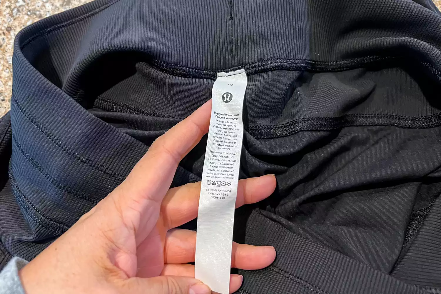 Person holding tag of lululemon Dance Studio Mid-Rise Jogger 7/8 Length