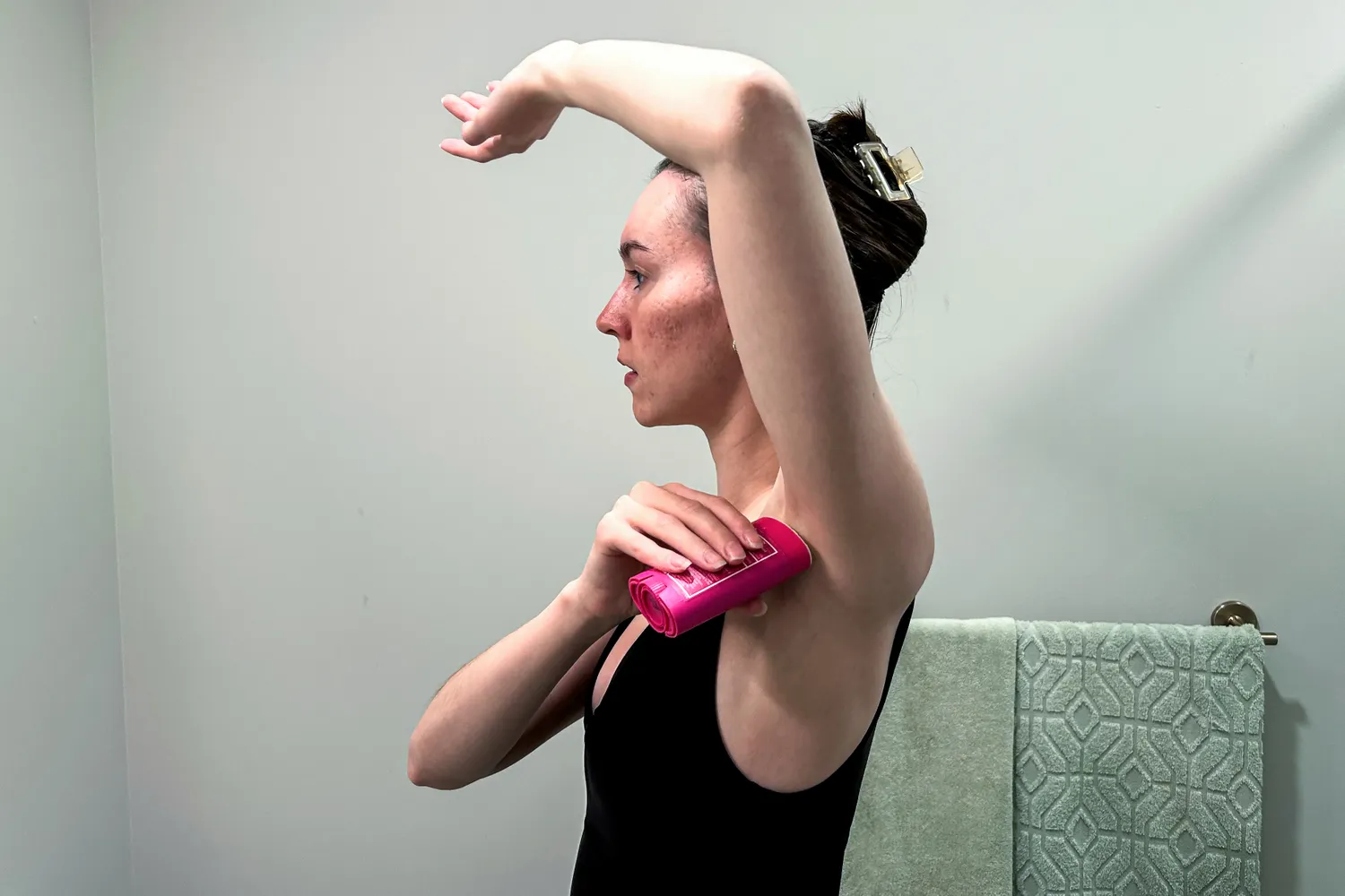A person applies Lume Solid Stick Deodorant Plus Sweat Control to their underarm