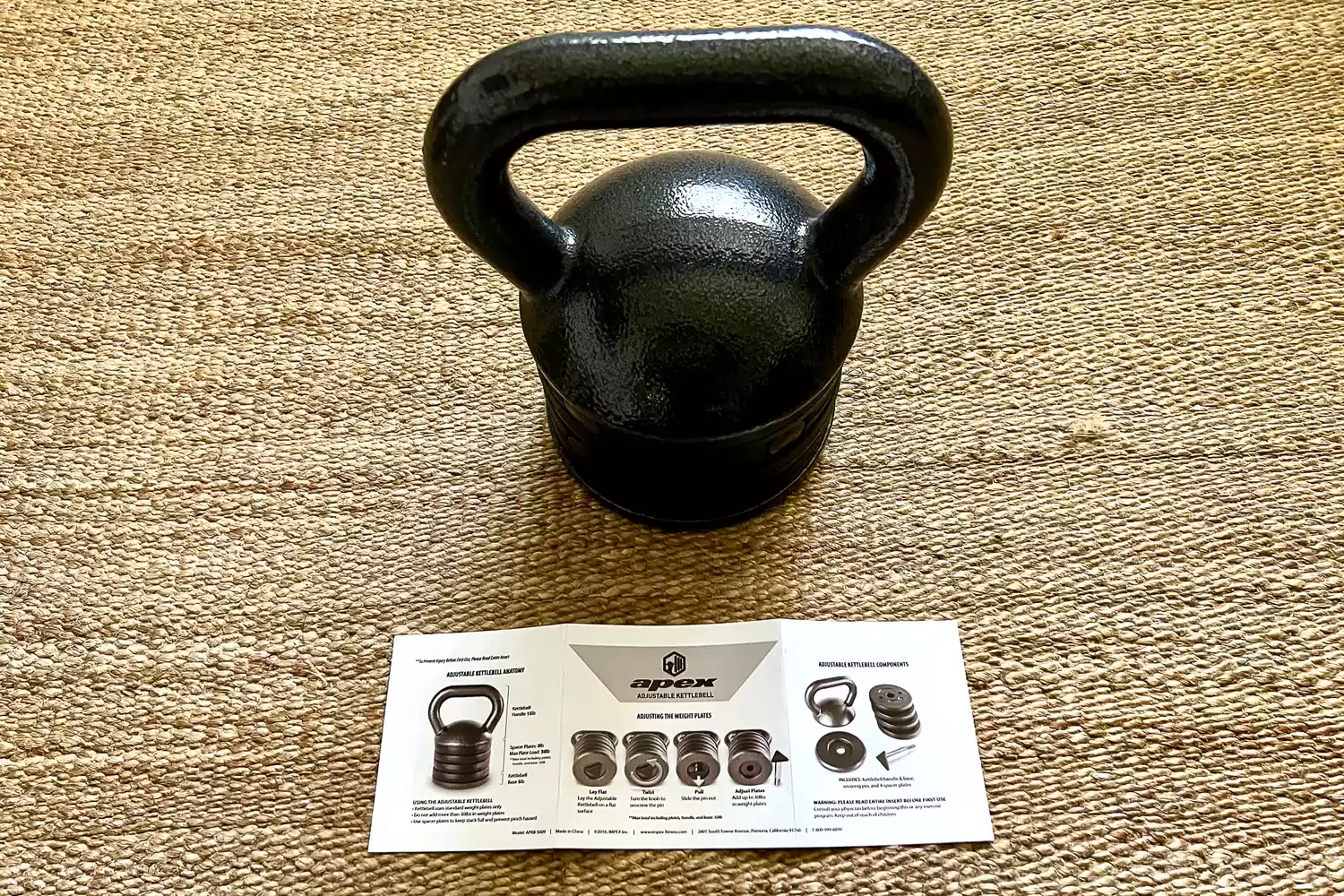 The Apex APKB-5009 Adjustable Heavy-Duty Kettlebell Set with instruction manual