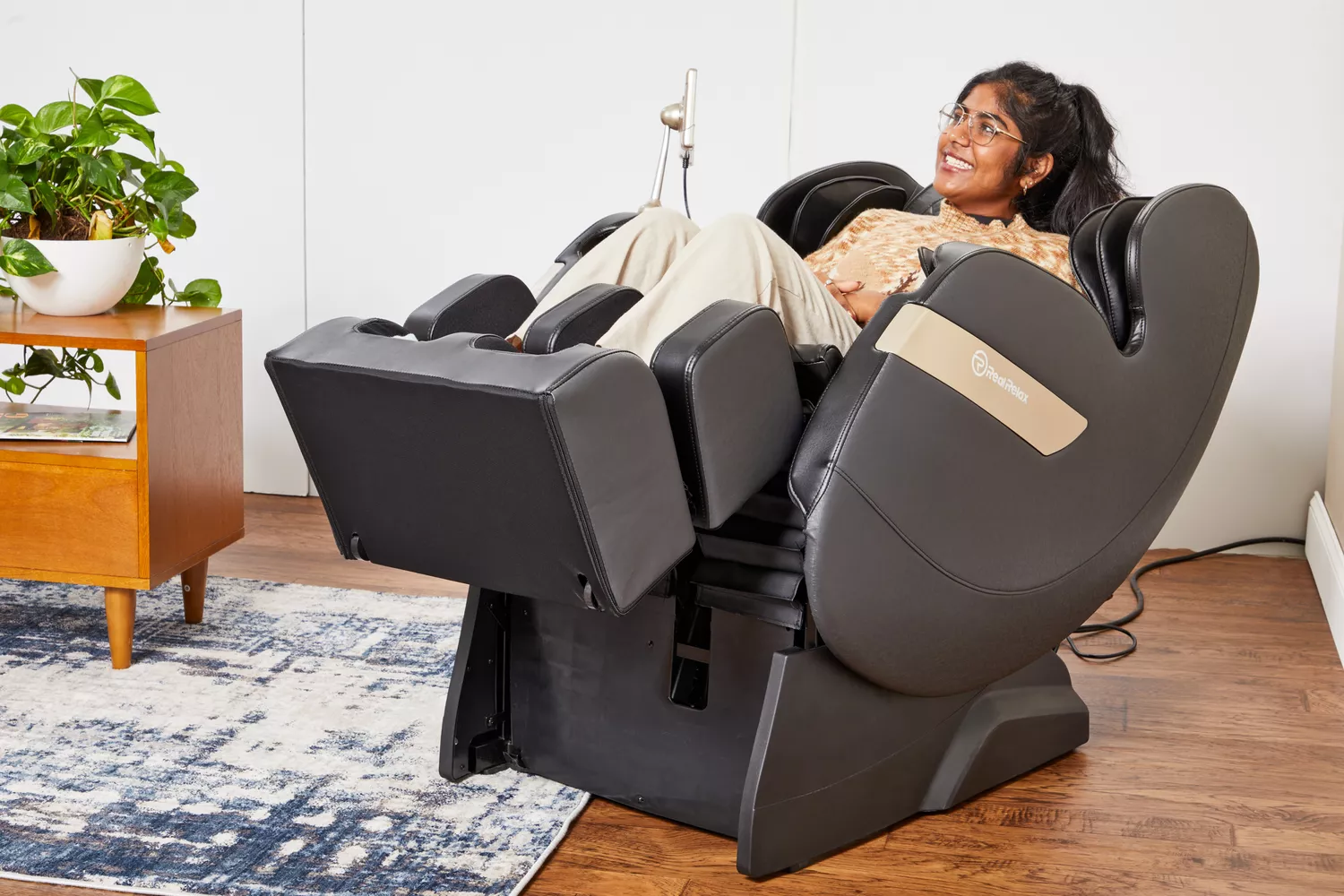 A person reclines in a Real Relax 2022 Favor-03 ADV Massage Chair