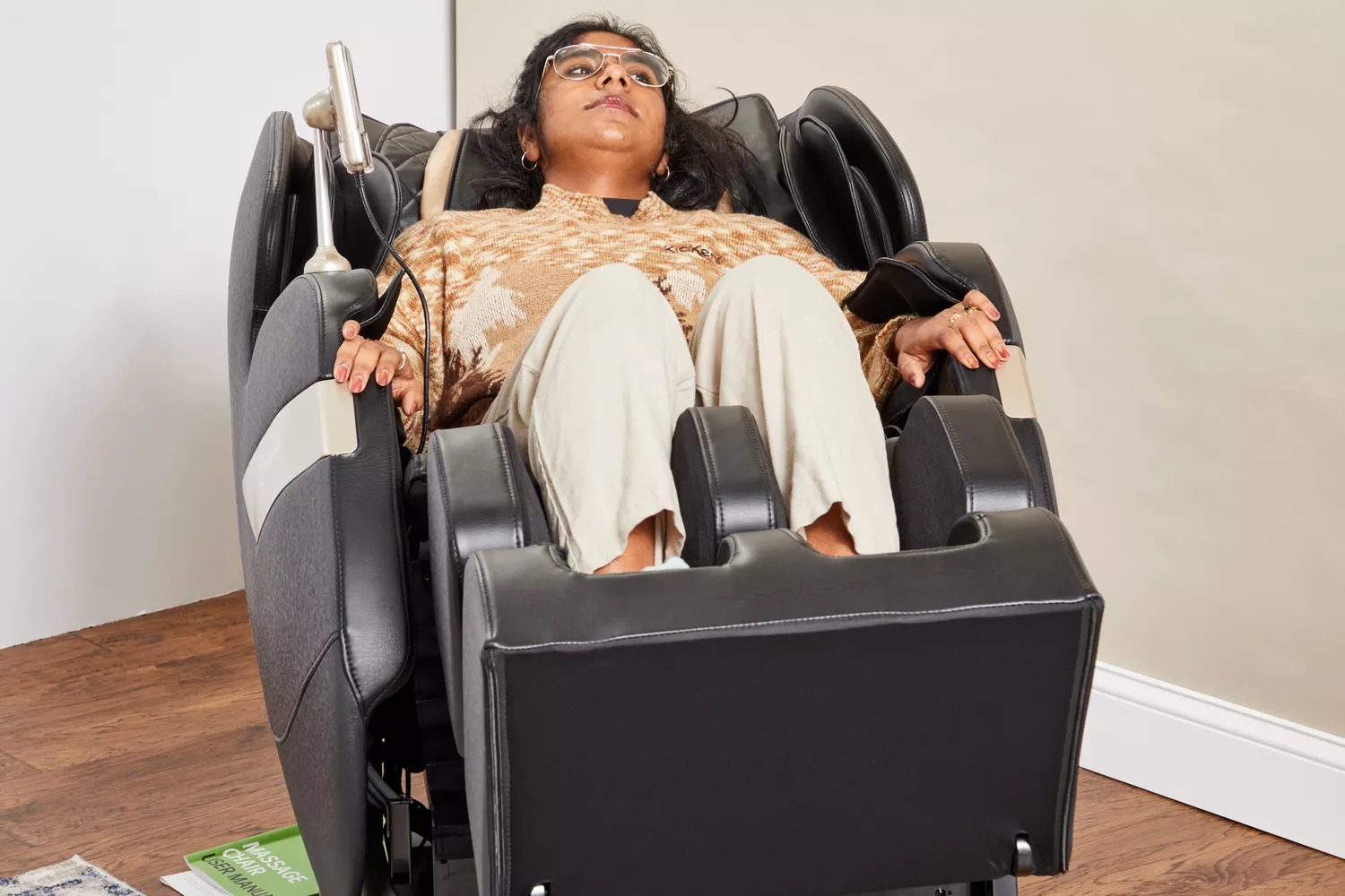 A person reclining in a Real Relax 2022 Favor-03 ADV Massage Chair