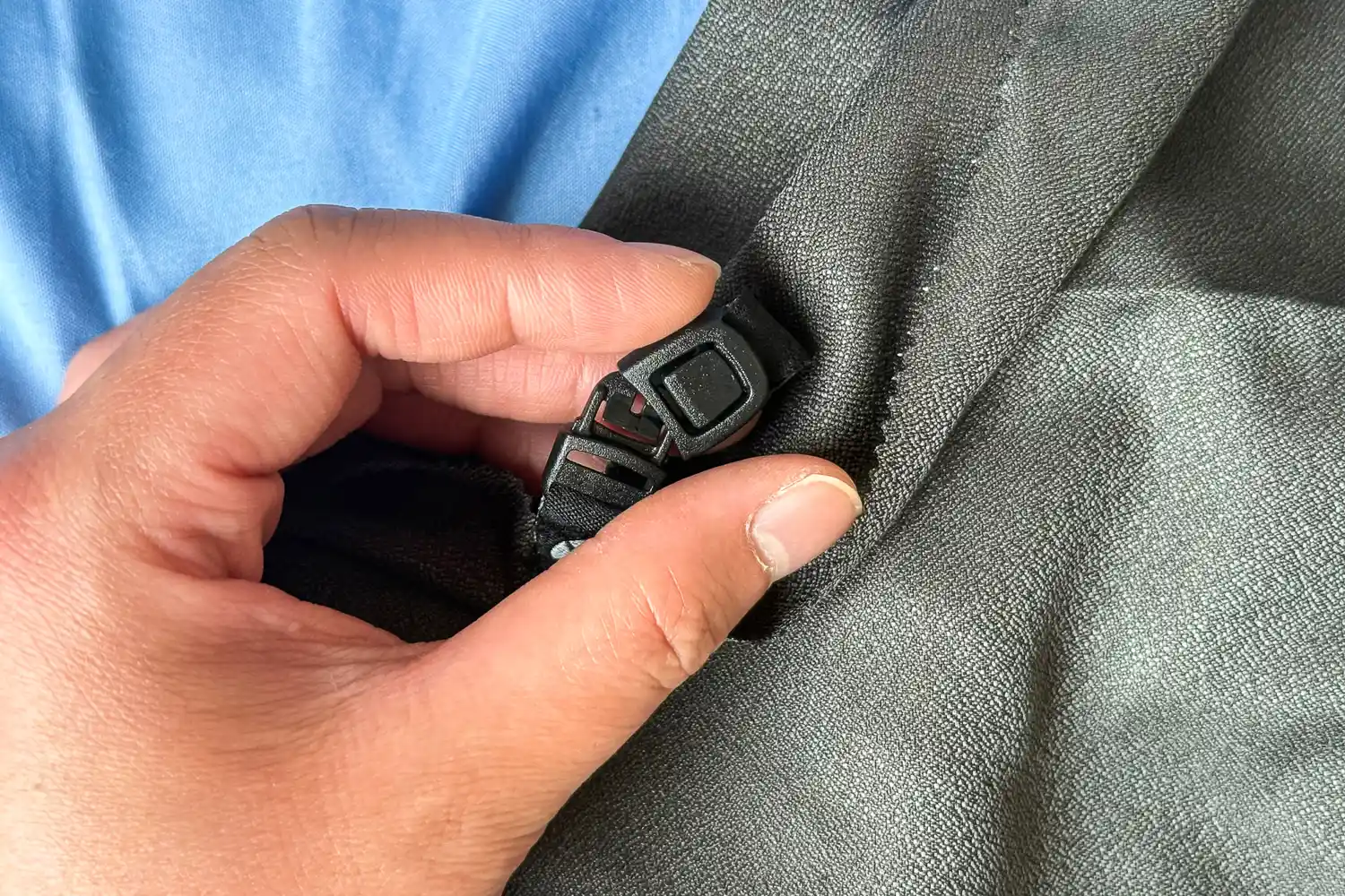 A person clips the Matador Nanodry Towel together