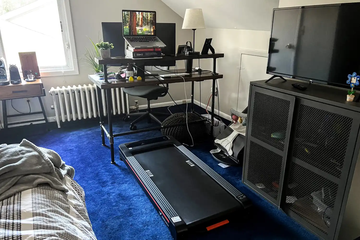 The Merach NovaWalk W50 TrekPad with Incline under a desk