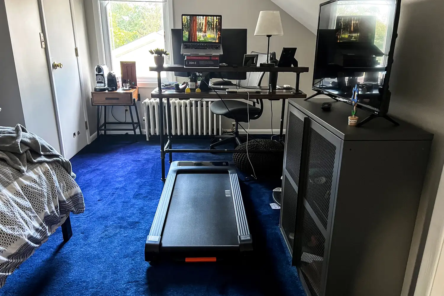 The Merach NovaWalk W50 TrekPad with Incline under a desk