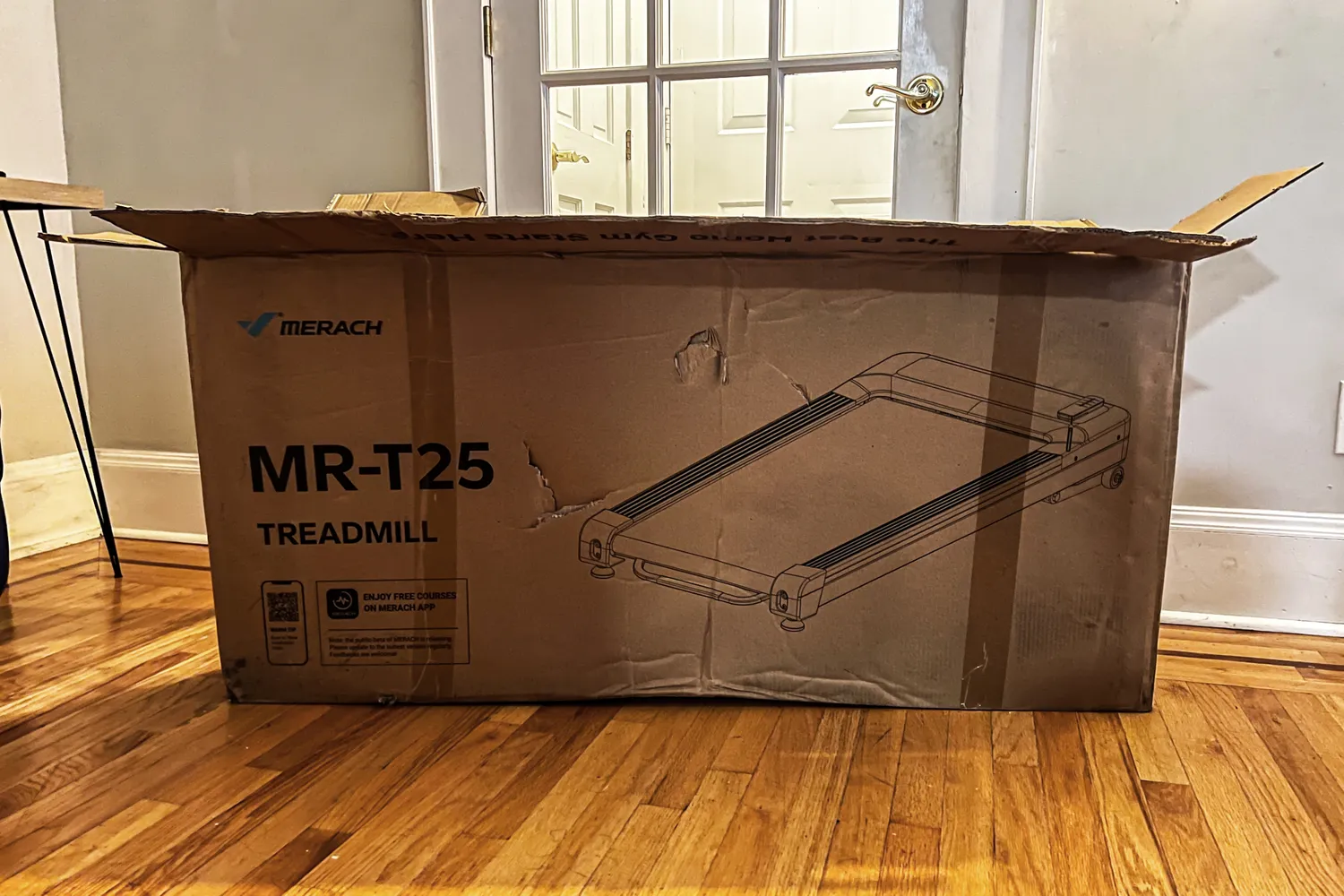 The Merach NovaWalk W50 TrekPad with Incline inside a cardboard shipping box