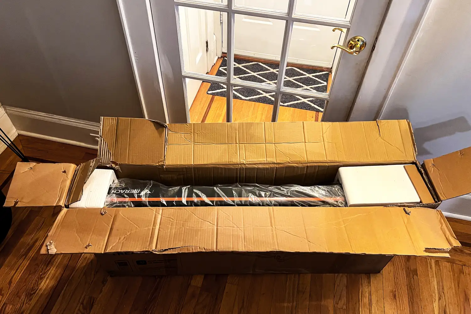 The Merach NovaWalk W50 TrekPad with Incline inside a cardboard shipping box