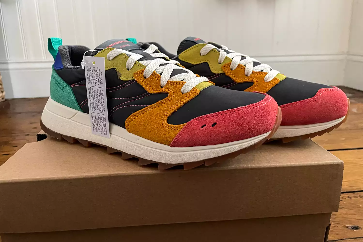 The Merrell Women's Alpine 83 Sneaker Sport sneakers with tags posed on their box