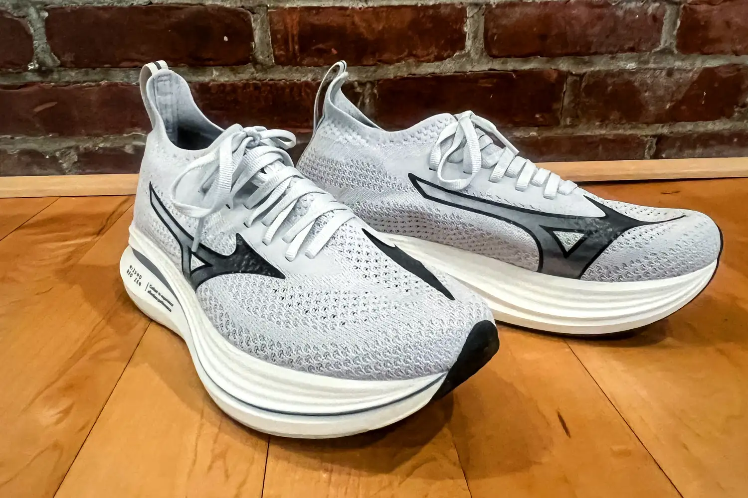 A front view of a pair of Mizuno Women's Neo Zen Running Shoes on a wooden floor