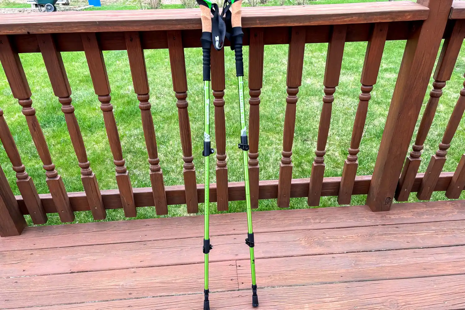 The Mountainsmith Tellurite 7075 OLS Trekking Poles lean against a railing