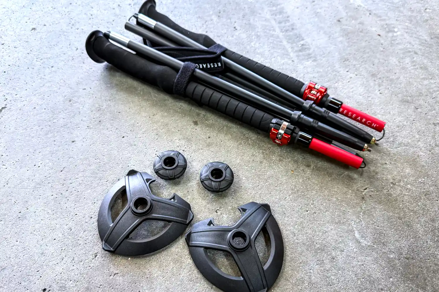 The Mountain Safety Research DynaLock Ascent Carbon Backcountry Poles folded on concrete