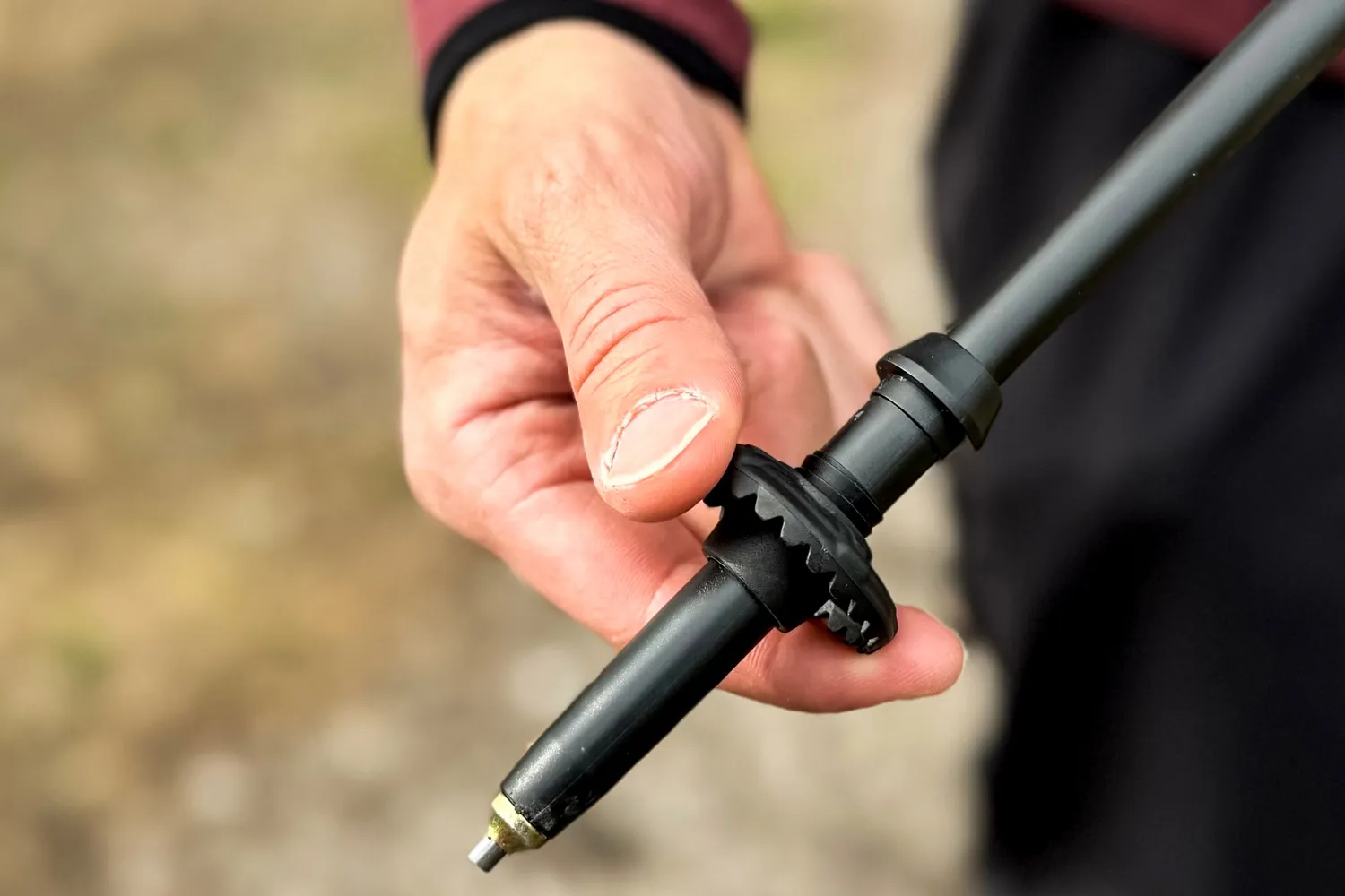 A person adjusts the Mountain Safety Research DynaLock Ascent Carbon Backcountry Poles