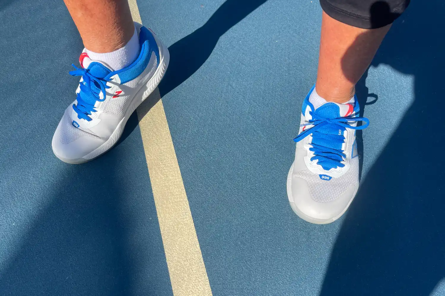 A person wears the New Balance Women's FuelCell 996v6 Pickleball Shoes on a court