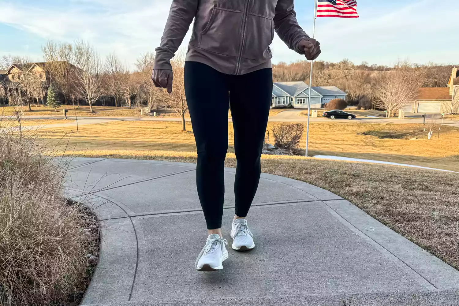 A person walking on a sidewalk while wearing the New Balance Women's Fresh Foam Arishi v4