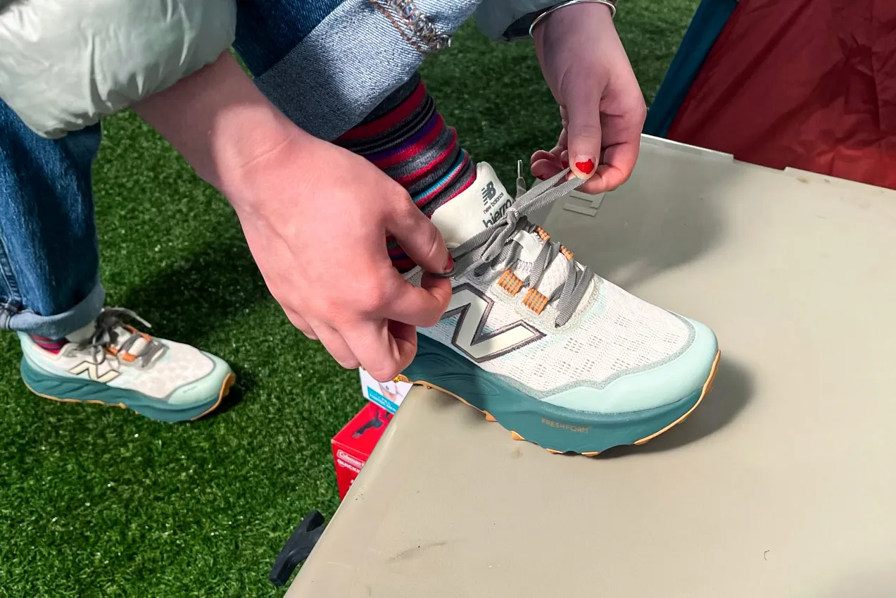 A person ties the laces on the New Balance Women's Fresh Foam X Hierro v9 Running Shoes