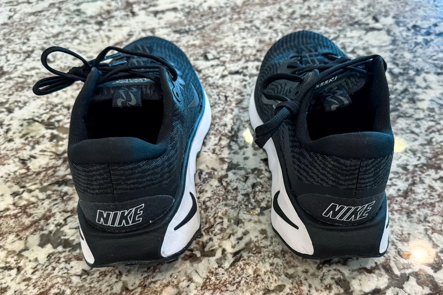 The brand name printed on the back of the Nike Motiva Women's Walking Shoes