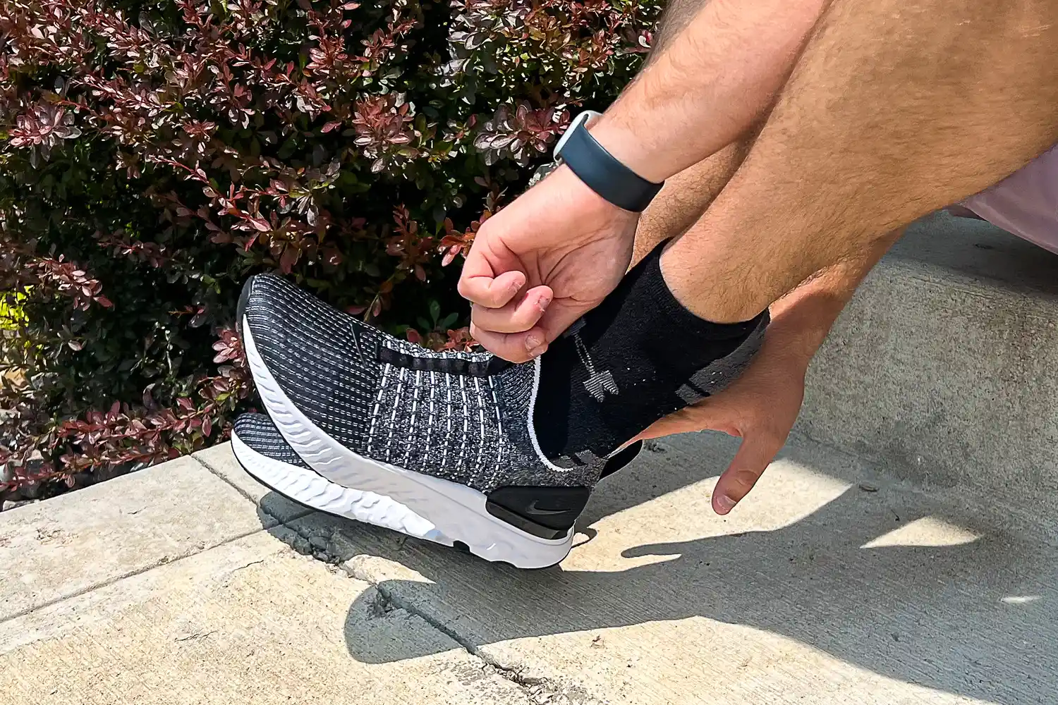 A person places the Nike React Phantom Run 2 Men's Road Running Shoe on their foot