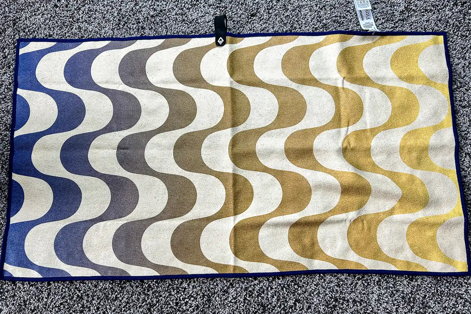 The Nomadix Fitness Towel on a gym floor
