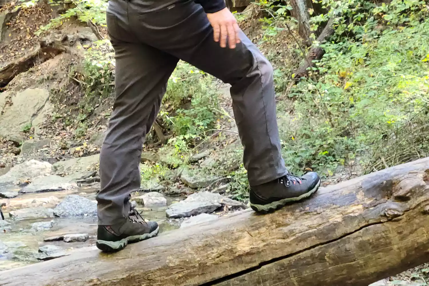 Legs and feet on a log wearing Oboz Bridger 9 Inch Insulated Waterproof Hiking Boot