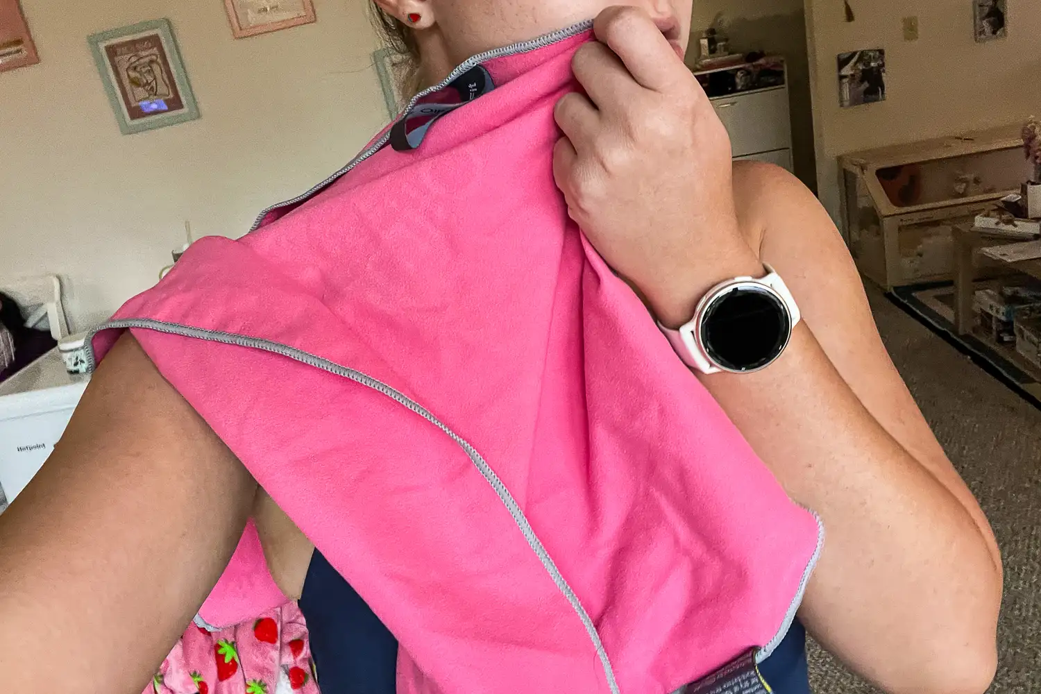 A person wipes their face with the OlimpiaFit Quick Dry Towel