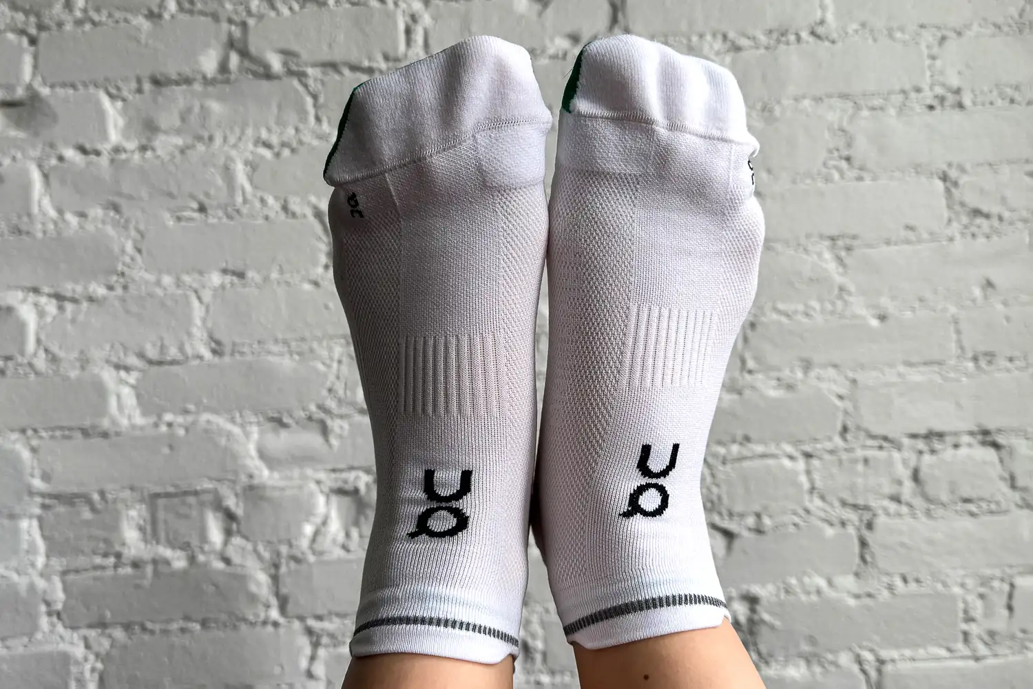A person wears a pair of On Running Elite Run Low Socks