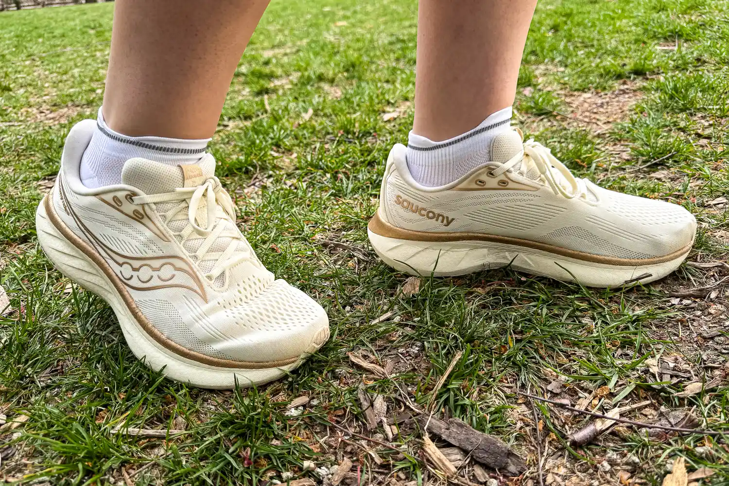 A person wears the On Running Elite Run Sock Low while walking outside